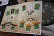 Mexican soccer players in a sticker album with funny faces, hats, and face masks next to an analog clock