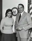 Avital Sharansky and Senator Bob Dole posing together in front of a U.S. Senate seal and American flag