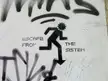Black and white graffiti on a white wall of a stylized running figure with the text ESCAPE FROM THE SISTEM