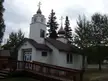 Old St. Nicholas Russian Orthodox Church, a white wooden building with blue trim and golden onion domes.