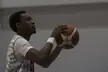 Terrence Drisdom in athletic wear holding a basketball on an indoor court, showing forearm tattoos.