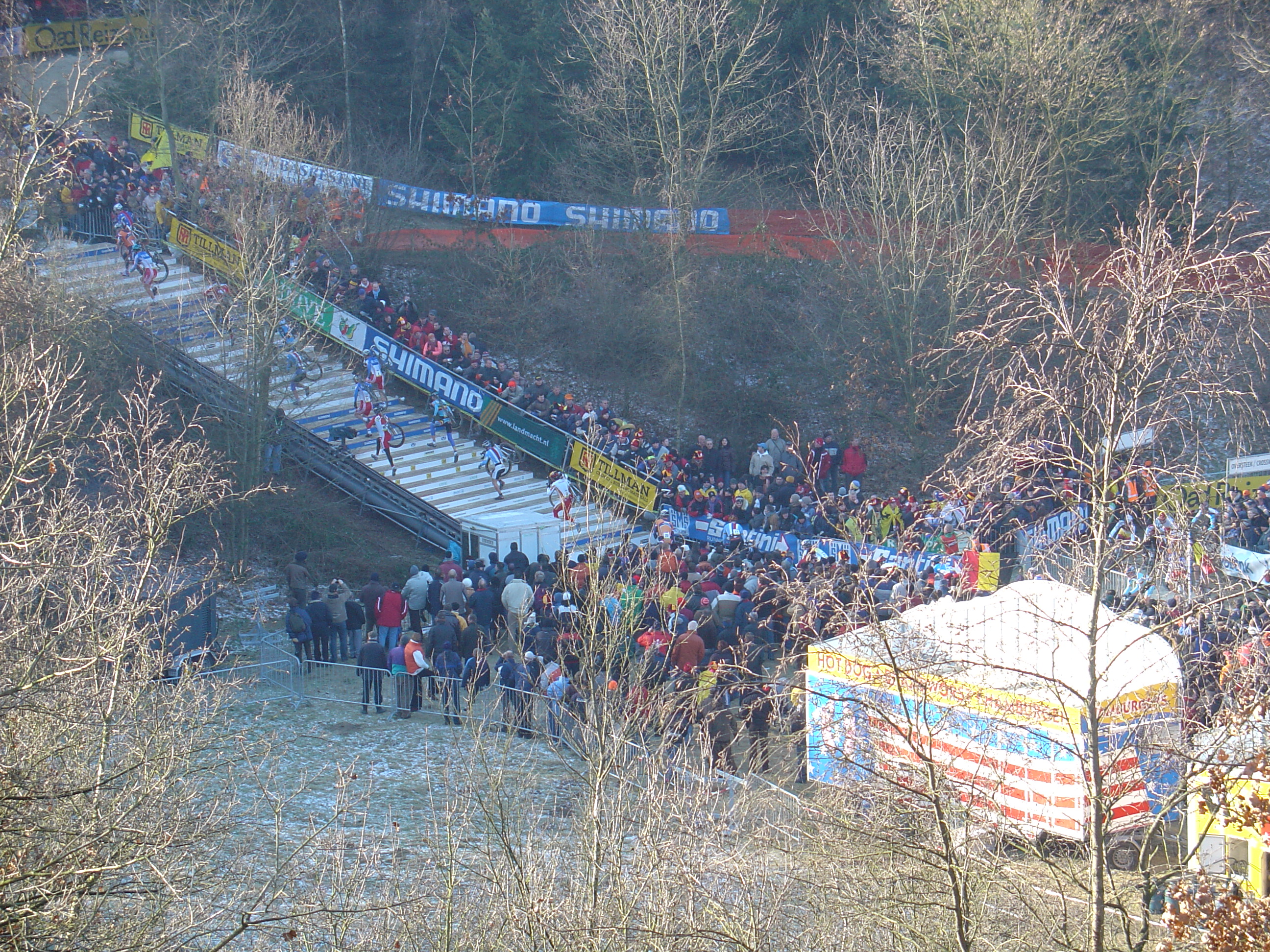 Riders (elite) running up the stairs with their bike