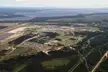 Vintage aerial photo of 5 Wing Goose Bay airfield, runways, and residential buildings by a lake and forest