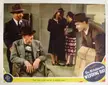 Lionel Barrymore in a wheelchair and Red Skelton with a group in mid-century fashion and hats