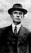 Tom Walsh, trade unionist, in a black and white vintage photo wearing a hat, suit, and tie.