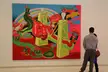 A couple viewing a colorful surrealist fine art oil painting at the Carnegie Museums of Pittsburgh