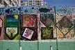 Abstract oil painting art and colorful graffiti mural on a concrete wall with a city skyline background
