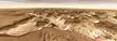 Noctis Vista on Mars from 2001 Mars Odyssey, showing rugged brown mountains and valleys under a pale sky.