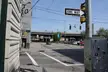 Urban city street in the North Shore of Pittsburgh, PA with a one-way sign, traffic light, and highway overpass