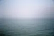 A minimalist 4k desktop wallpaper of the calm Dagestan ocean meeting a pale, clear sky at the horizon.