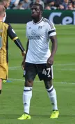 Kamara in a white Fulham jersey and black shorts with number 47 on a green soccer field