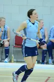 Maxifuels Supersixes 2 Day 2 C 699 female athlete in a light blue tank top and navy skirt with a field hockey stick