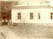 A dacha near Moscow in 1917 with people in white shirts and dresses on the porch