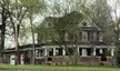 Farmhouse on the National Register of Historic Places in Minnesota, a two-story brick house with a large porch.