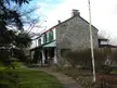 Northbrook Historic District stone house with green shutters and a brick walkway