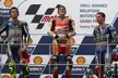 Valentino Rossi, Marc Márquez and Jorge Lorenzo in racing suits on a MotoGP podium
