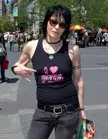 Jett wearing a black 'I heart PETA' tank top, skinny jeans, and sunglasses on a New York City sidewalk