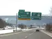 NY 17 and I-81 highway merge in winter with green overhead signs for Scranton and Binghamton