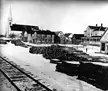Rogersville in 1910: black and white vintage photo of a snowy town street with railroad tracks and stacked lumber