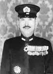 Raizo Tanaka in a black and white vintage photo wearing a dark military uniform with medals and a peaked cap