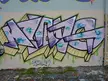 Fang graffiti art featuring purple and white abstract designs on a wall with the signature METASTIK