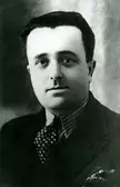 Odoardo Focherini in a black and white professional portrait wearing a dark suit and polka-dot tie.