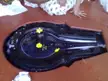 Vulva represented by a black stone Shiva Lingam with yellow flowers and Indian women in white dresses.