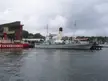HSwMS Spica and SS Sankt Erik docked at a harbor with a cloudy sky