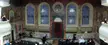 The Tsori Gilod Synagogue in Lviv featuring ornate wall paintings, arched windows, and a group of people