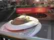 Flying saucer futuristic silver structure in front of a red MARS 2112 restaurant building on an urban city street