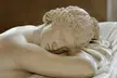 Sleeping Hermaphroditus marble sculpture, a close-up of a shirtless figure with curly hair lying down