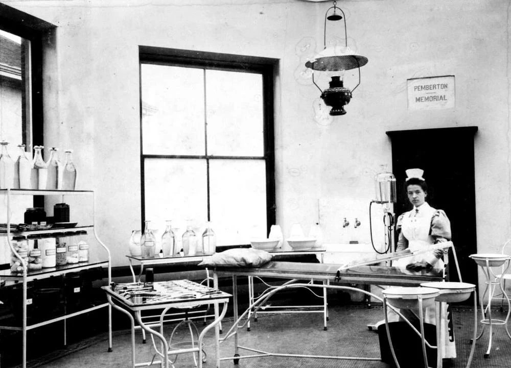 The operating room, circa 1900. Above the door can be seen a marble slab with the words "Pemberton Memorial" carved into it, which was required per the agreement for funding.