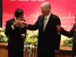 Vice President Wu and two other men in dark suits and white shirts clinking glasses at an event.