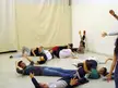 Israeli girls from a theater program lying on a floor in casual athletic wear and blue denim skinny jeans