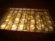 Baby brûlées in small glass jars baking in a water bath inside an oven.