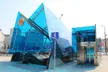 Dworzec Wileński metro station entrance with blue glass architecture, an escalator, and an elevator in Warsaw