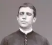 Fr. Donizetti in a black and white vintage photo wearing a dark clerical collar.