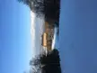Karugamo Run and Appi Hills Shirakaba-No-Mori 3 resort building in a snowy mountain landscape with a small figure