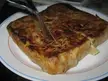 A square-shaped Murtabak Spanish tortilla on a white plate with a metal serving utensil, close-up and oddly satisfying.