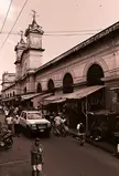 Mercado Municipial in Granada with market stalls, a white SUV, and people in streetwear