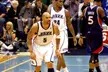 Carlos Boozer and teammates in white and blue Jazz uniforms on an indoor basketball court.