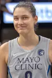 Beautiful athletic woman with brown hair wearing a grey Minnesota Lynx basketball jersey with Mayo Clinic branding.