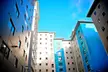 Opal Court modern apartment buildings with blue and grey facades against a clear blue sky