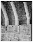 Black and white close-up of the Thirty-third Street Bridge in Philadelphia showing brick arches and a stone wall