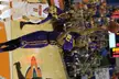 Quarterman in purple LSU athletic wear and tights shooting a basketball during a game.