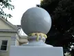 Adheezed concept art of a grey stone sphere on a pedestal with yellow drippy wax