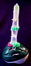 Cursed image of a bicycle helmet with a tower of plastic bottles and a condom on top