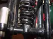 Close-up of a black metal spring and frame assembly for a YFCC100M motorcycle