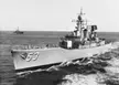 Black and white vintage photo of a destroyer escort with number 53 on the bow sailing in the open sea
