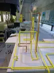 Abstract art oil painting of yellow and copper pipes in acrylic boxes on a white table, labeled HOSPITAL NURSE